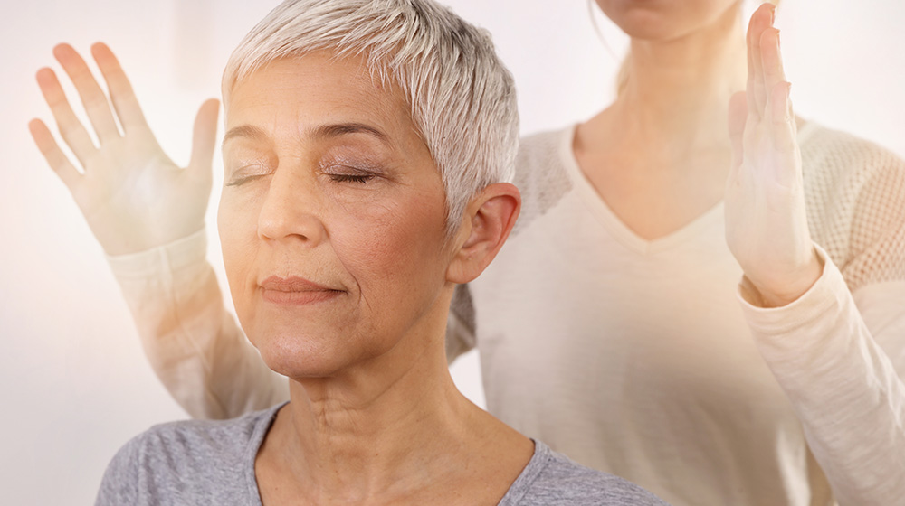 Woman having reiki healing treatment , alternative medicine concept, holistic care
